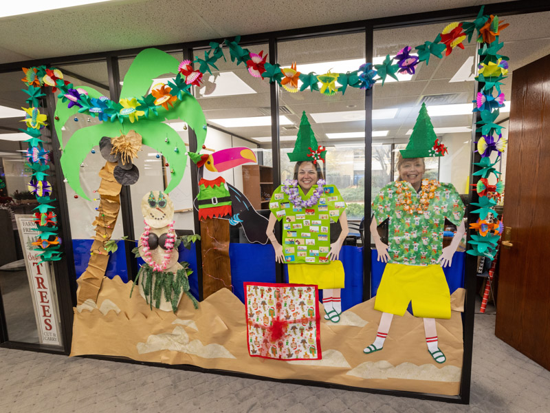 April Giavotella, left, manager of human resources operations and special projects, and Chief Mary Paradis of the UMMC Police and Public Safety Department, enjoy beach-themed holiday decorations. Jay Ferchaud/ UMMC Communications 